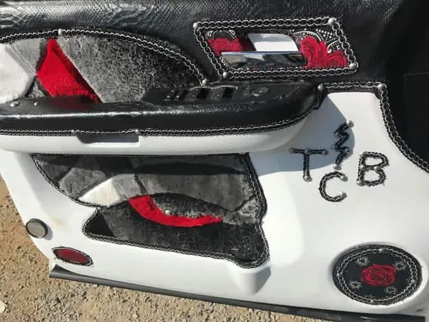 Finished custom door panel wrapped in leather and suede with stitched TCB lettering