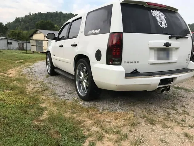 Rear three-quarter view of the finished custom Tahoe on 24-inch wheels