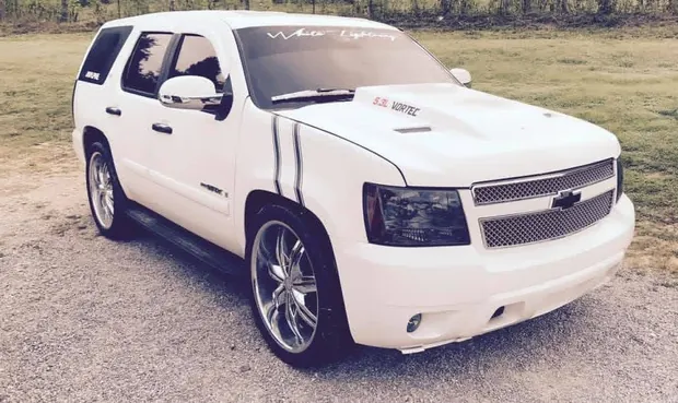 Custom Tahoe body kit, lowered stance and polished 24-inch wheels