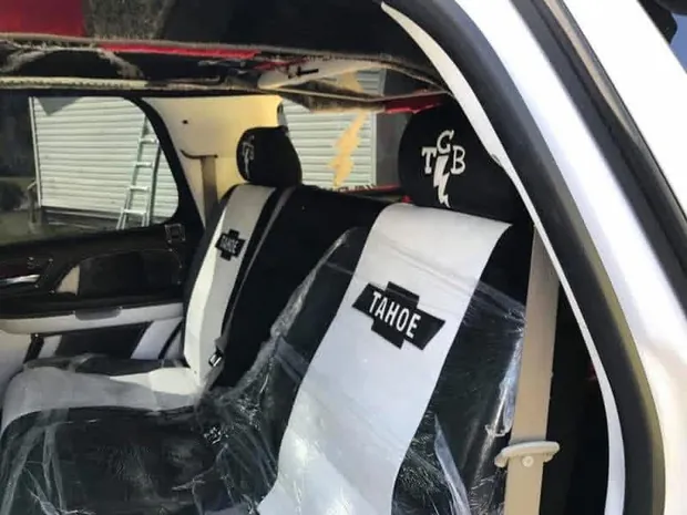 Custom front seat covers fitted in white and black with embroidered Tahoe lettering