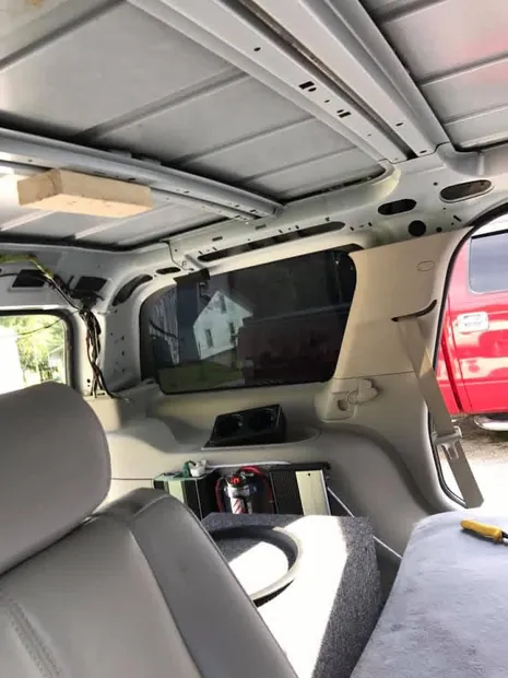 Custom interior with overhead flip-down monitor and rear entertainment wiring