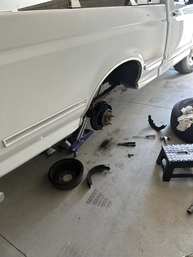 Pickup truck on jack stands for a mobile brake and wheel job