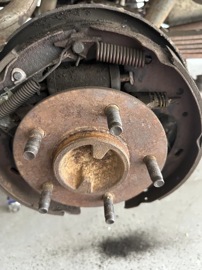 Rear drum brake and hub inspected during a mobile brake service